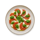 Insalata Caprese on stoneware bowl with Basil, mozzarella, Olive Oil