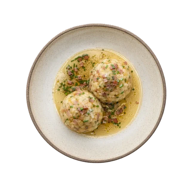 Canederli on stoneware bowl with Bread, Butter, Egg