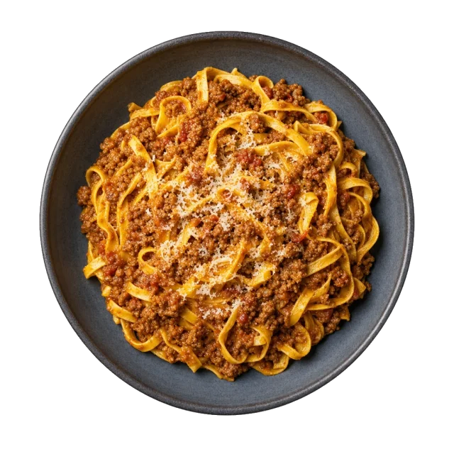 Tagliatelle al ragu alla bolognese in a dark stoneware bowl, topped with grated parmesan