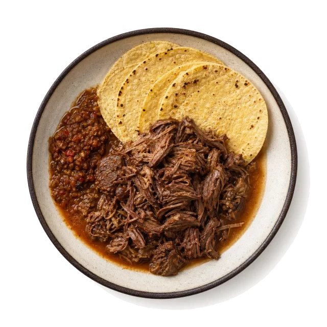 Barbacoa plated with beef, lamb, chili