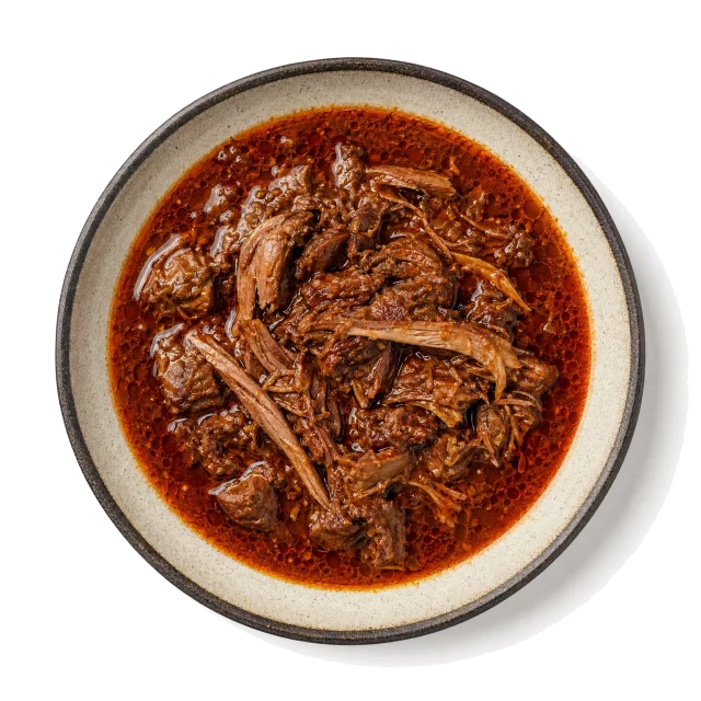 Birria plated with beef, lamb, chili