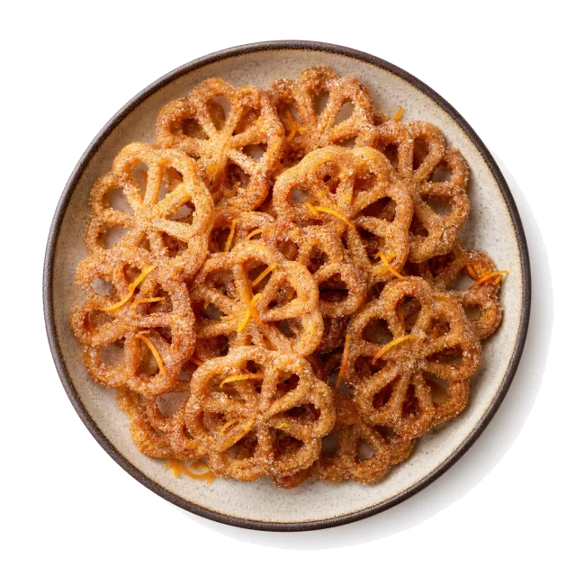 Bunuelos plated with flour, sugar, cinnamon