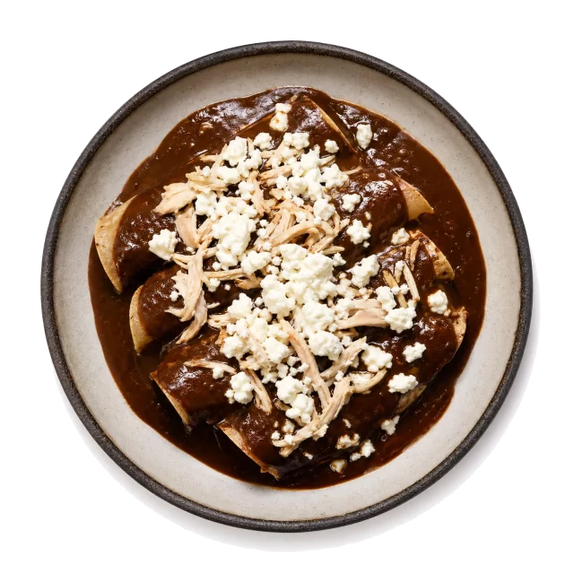 Enmoladas plated with corn tortilla, chicken, chocolate