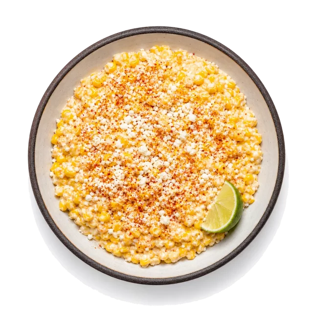 Esquites plated with corn, cream, queso fresco
