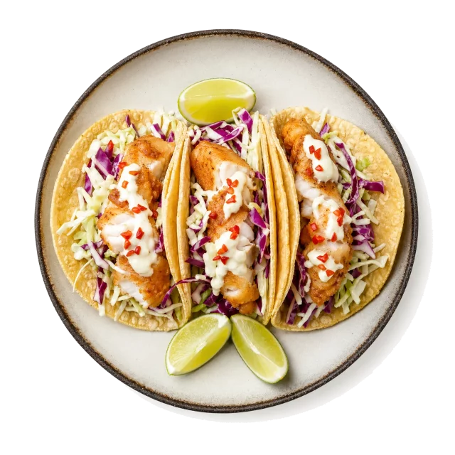 Fish Tacos plated with cod, corn tortilla, cabbage