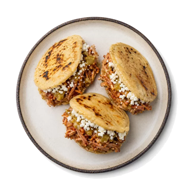 Gorditas plated with corn, corn tortilla, pork