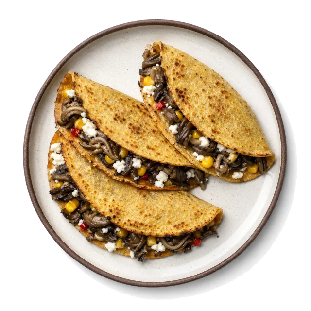 Huitlacoche Quesadillas plated with corn tortilla, queso fresco, straw mushroom
