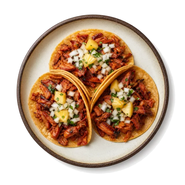 Tacos al Pastor plated with pork, orange peel, corn tortilla