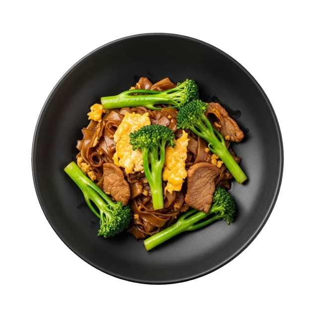 Pad See Ew broad rice noodles in a black bowl with gai lan, egg and sliced pork