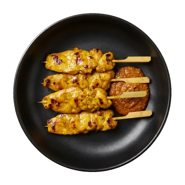 Satay: Thai chicken satay skewers: 4 grilled chicken skewers arranged in parallel in the bowl, gl