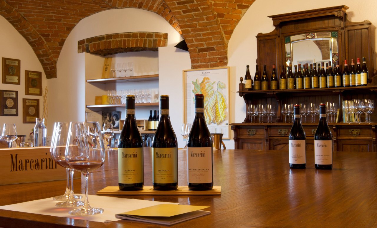 Bottles and tasting glasses in the Marcarini wine shop in La Morra
