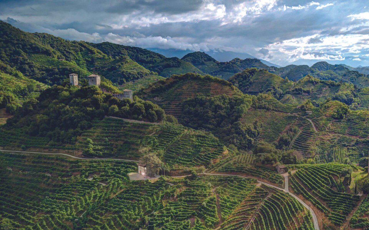 The medieval Torri di Credazzo towers above the Follador vineyards at Col San Martino, seen from the air