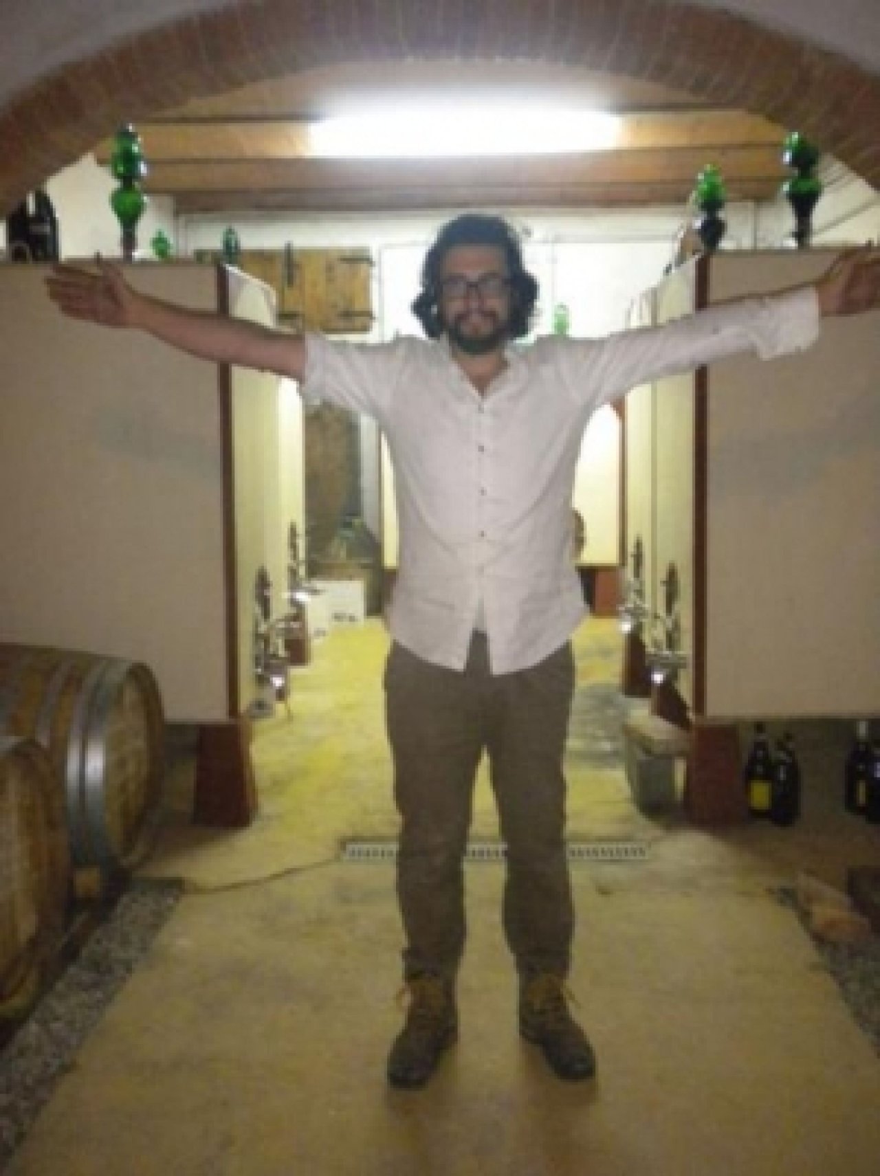 Stefano Amerighi between the concrete fermentation vats in his cellar