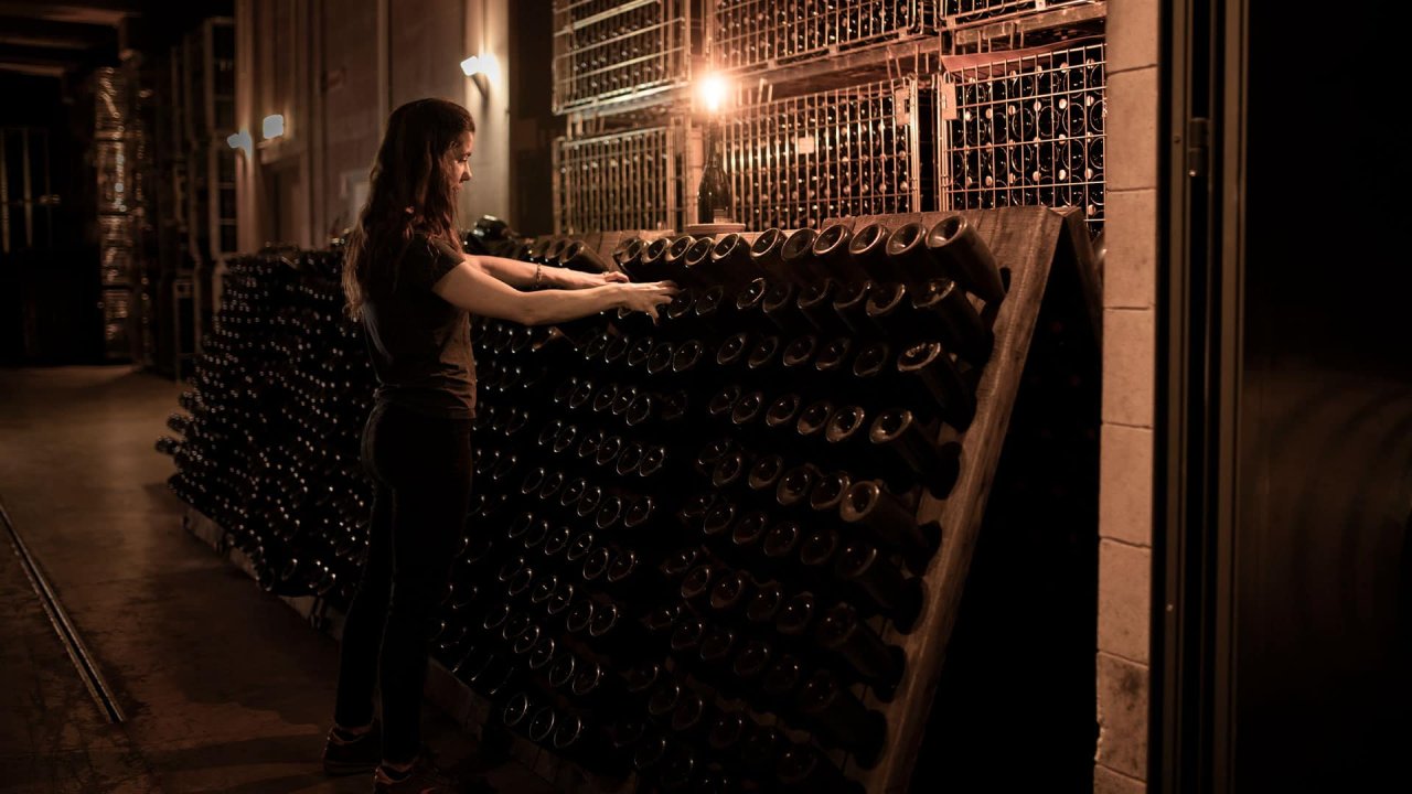 Bottles of Barone Pizzini Franciacorta resting in the cellar