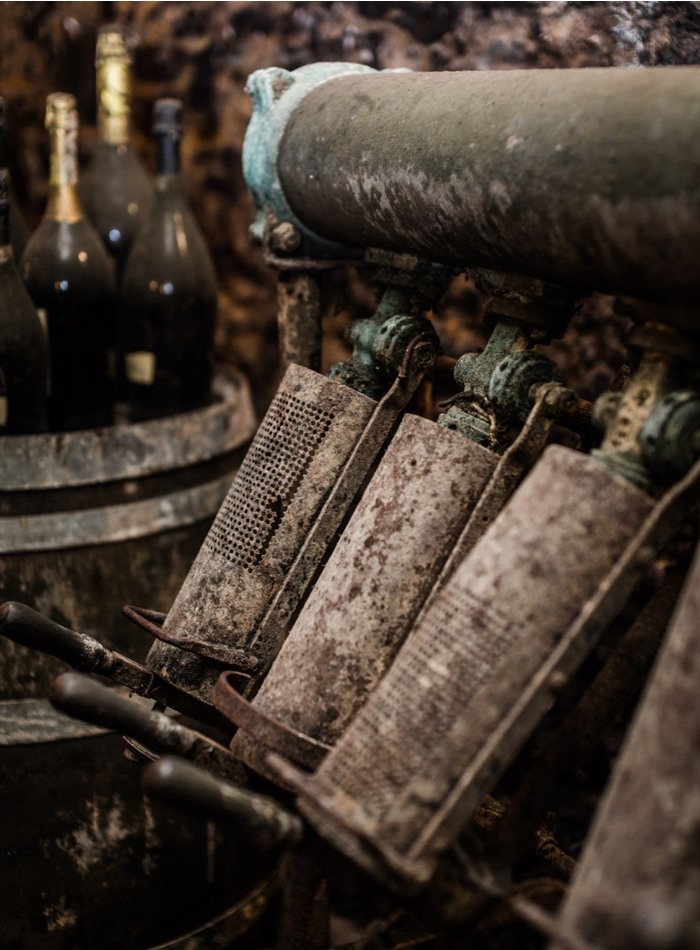 Old riddling gear and bottles in the historic Bisol cellar