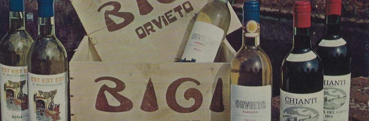 Old wooden Bigi Orvieto wine cases beside vintage bottles of Orvieto Classico, Chianti and Est Est Est