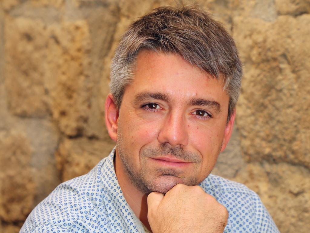 Bigi winemaker Paolo Nardo in front of a stone wall