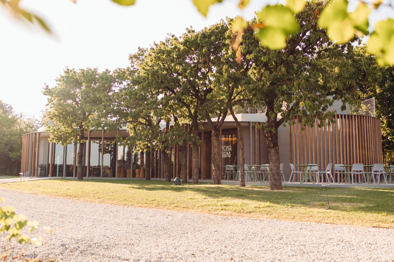 The wooden Officina del Vino visitor building at Cantina Pizzolato, seen from the lawn