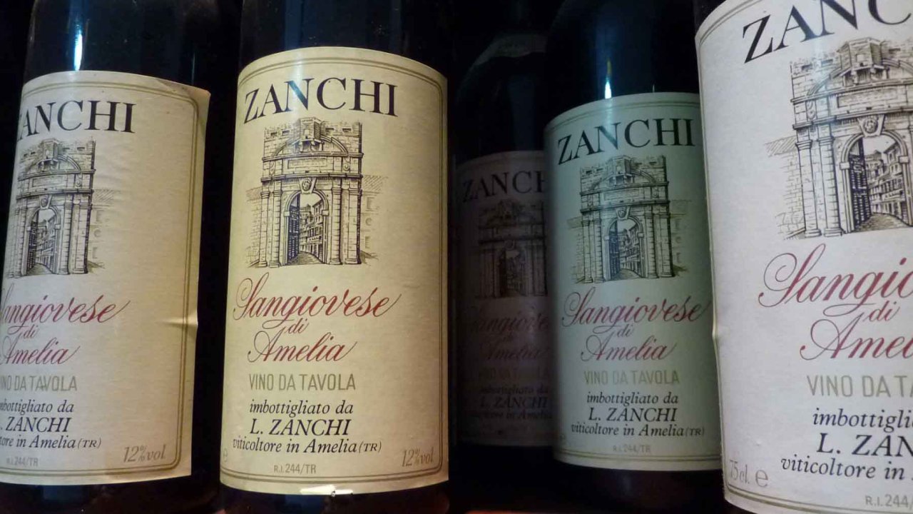 Old bottles of Sangiovese di Amelia with labels reading L. Zanchi, viticoltore in Amelia
