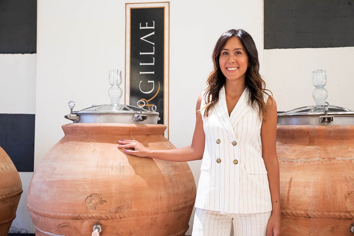 Giulia, the founder's granddaughter, beside terracotta amphorae in the Argillae cellar