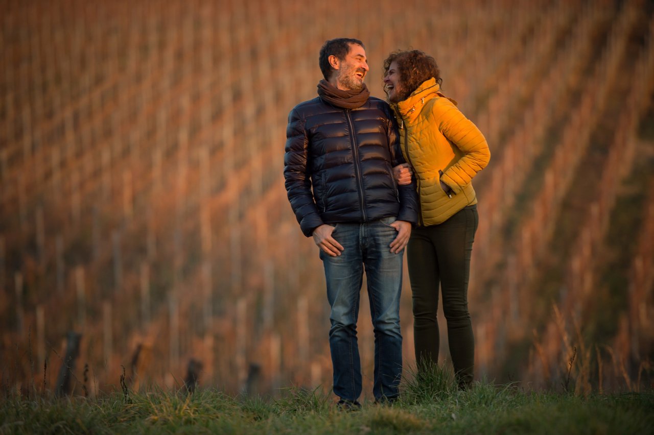 Paolo and Ana of Le Moire standing together among the vines
