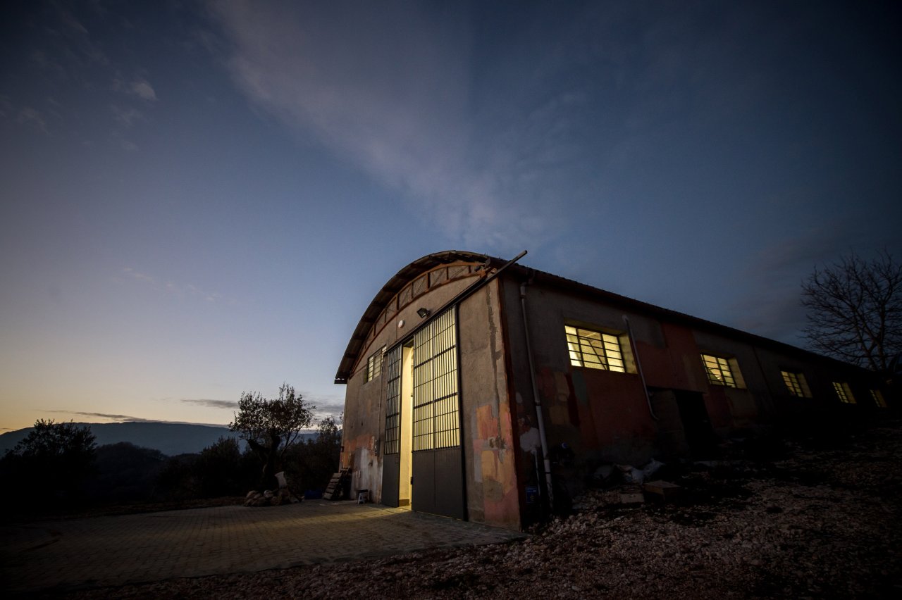 The Le Moire winery building at dusk, its glass doors lit from inside