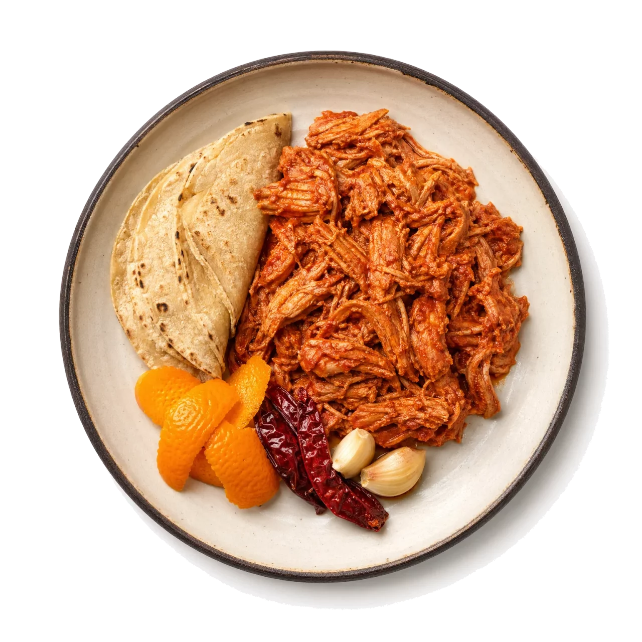 Cochinita Pibil plated with pork, orange peel, chili