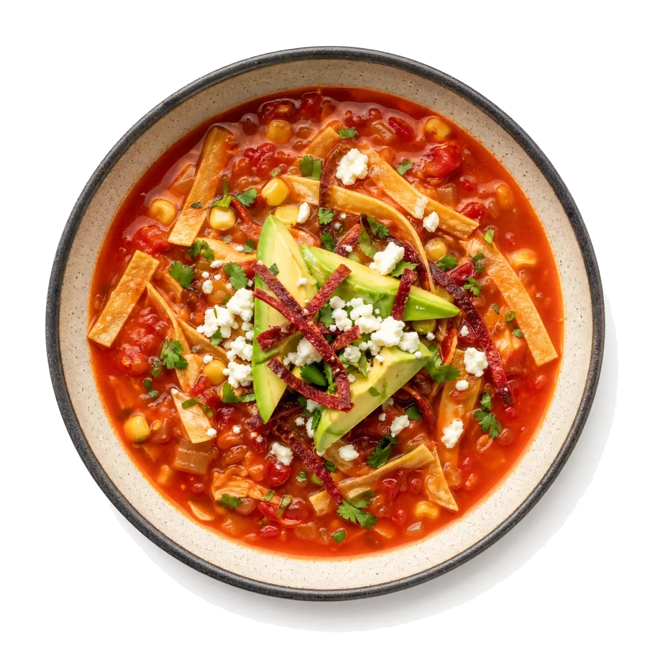 Sopa de Tortilla plated with corn tortilla, tomato, chili