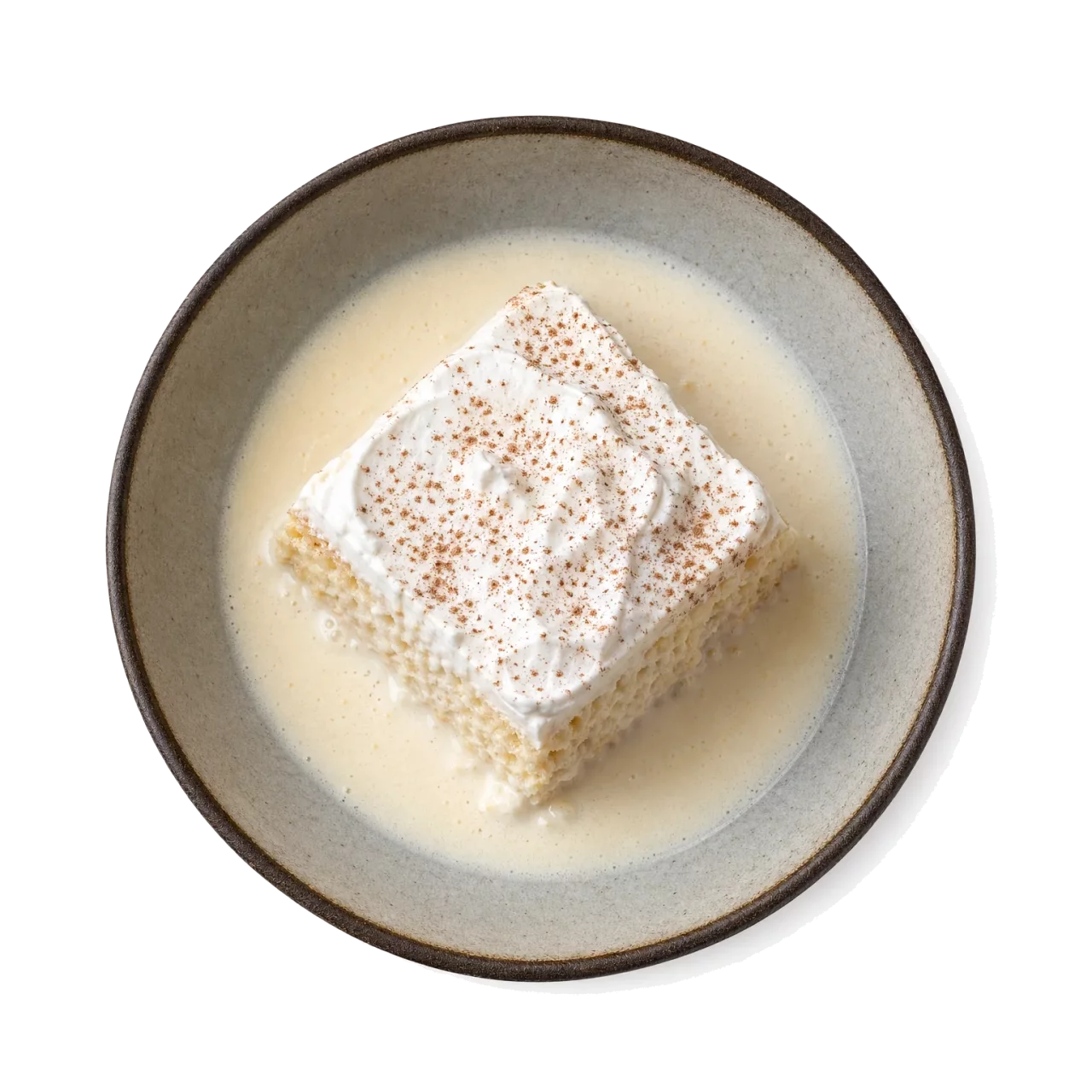 Tres Leches Cake plated with milk, cream, sugar