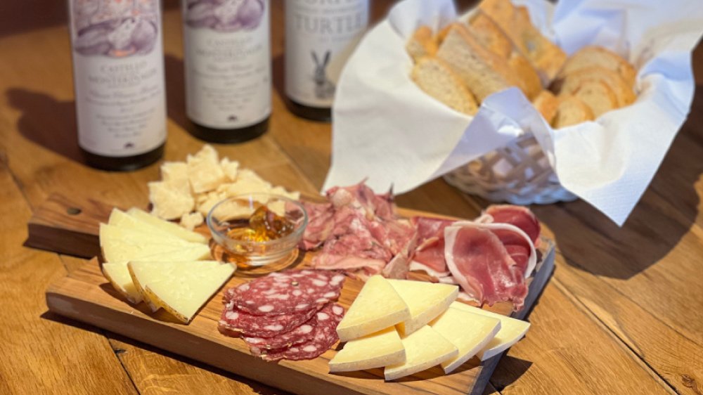 Three wines with a board of local cured meats and cheeses at Castello di Monterinaldi