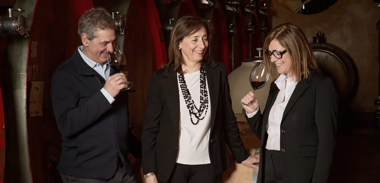 Riccardo, Antonietta and Sabrina Tedeschi standing together in the barrel cellar